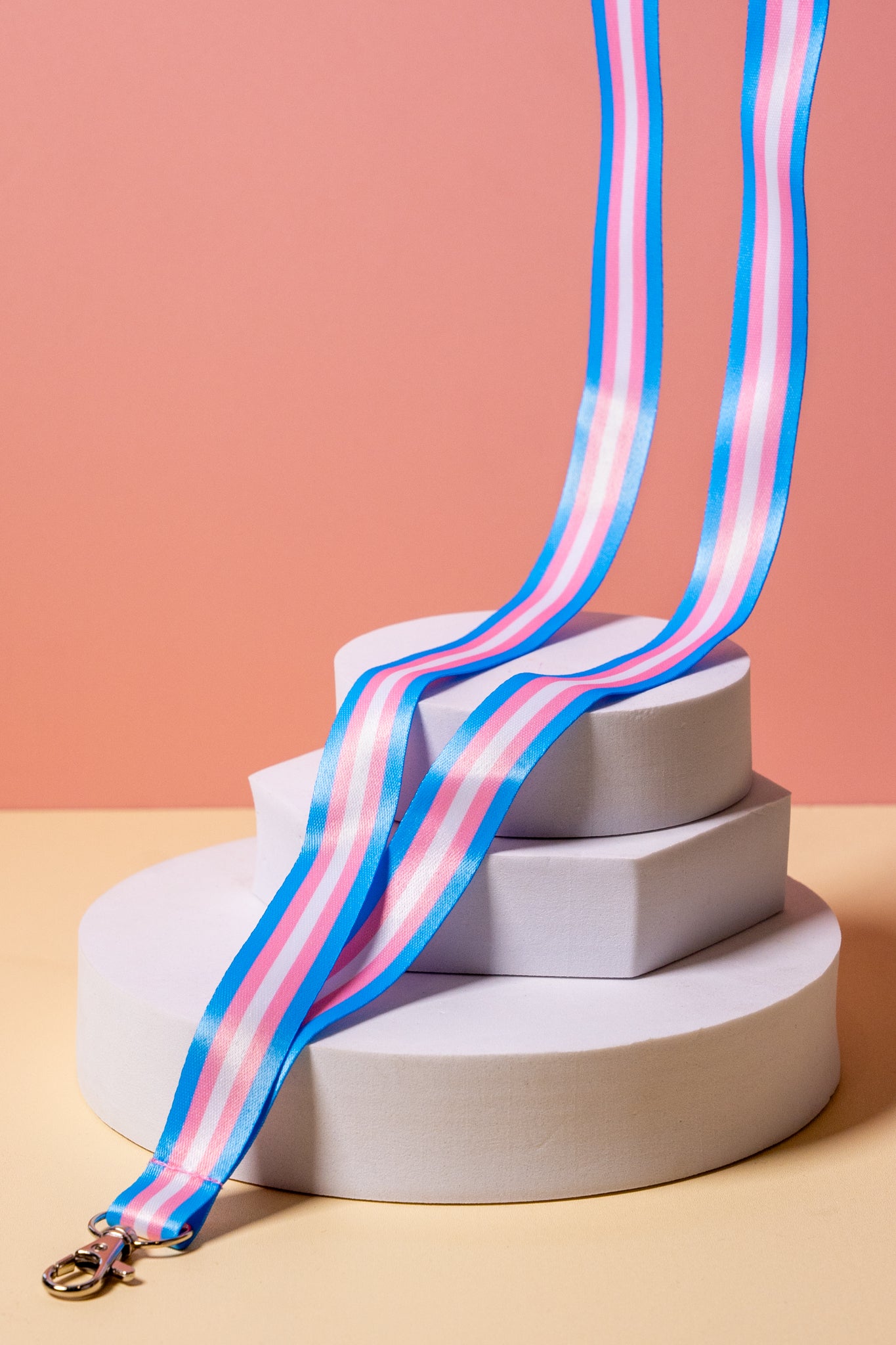 A blue pink and white striped lanyard on a display